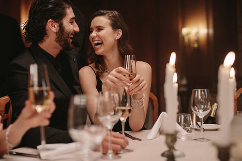 Cheerful couple at gala night dinner
