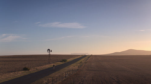 Professional cyclist practicing on countryside landscape road
