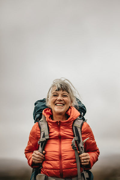 Close up of a smiling female hiker standing outdoors