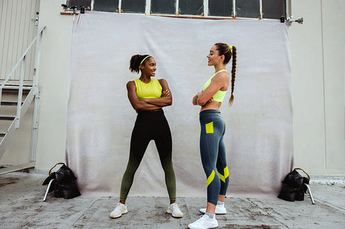 Two women in sportswear on a rooftop