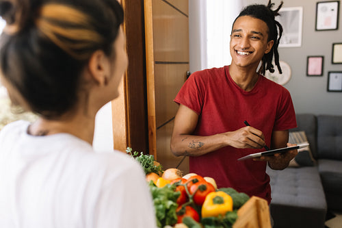 Man receiving a grocery delivery at home