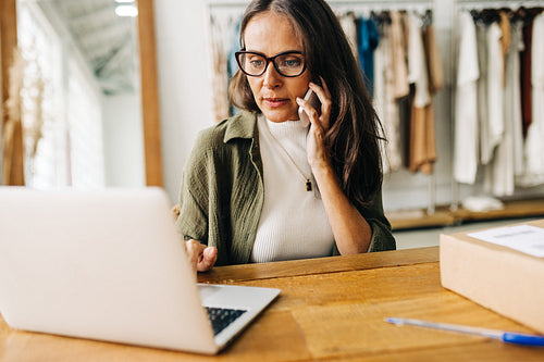 Ecommerce business: Woman making a phone call to her shipping partners