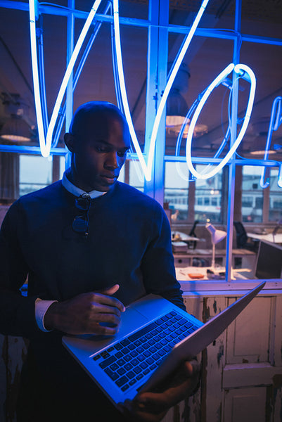 Young man in office working on laptop