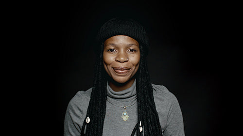Cheerful woman with long dreadlocks