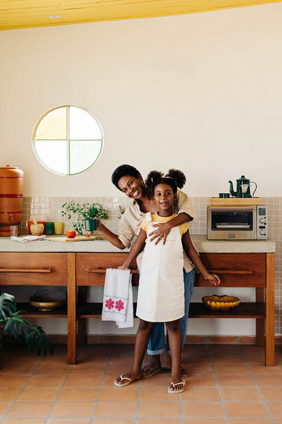 Brazilian mother and daughter bonding in kitchen