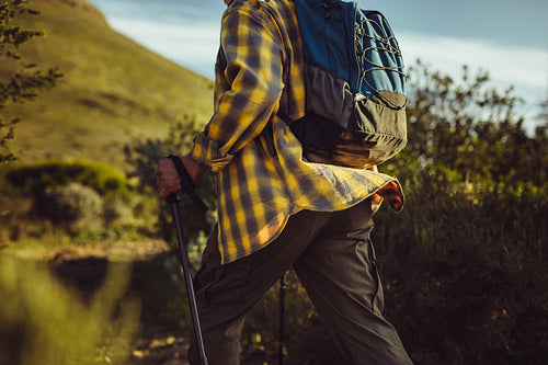 Rear view of a man hiking on a hill