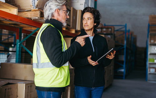 Mature warehouse managers having a discussion