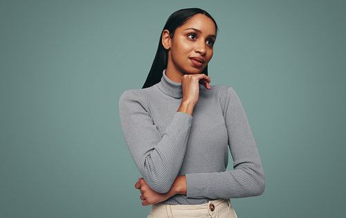 Gorgeous young woman looking away in a studio