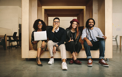 Business partners sitting together in office in an enclosure