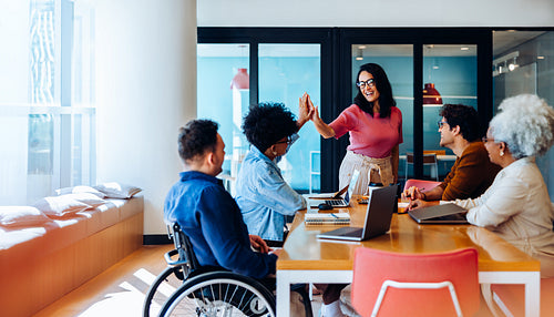 Teammates exchange a high-five in celebration