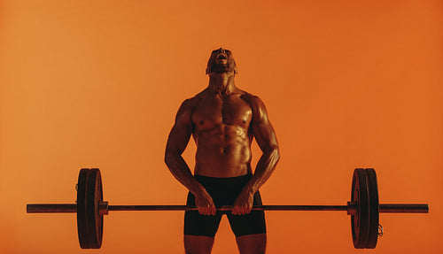 Muscular man training on lifting weights