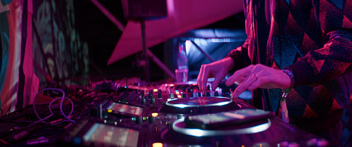 Energetic dj spinning decks at a music festival