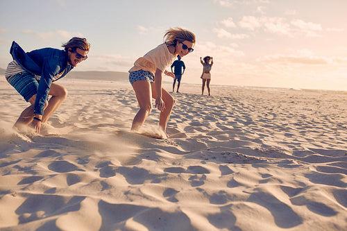 Couple of friends running a race on the beach