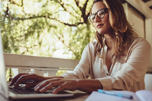 Businesswoman at cafe working on laptop