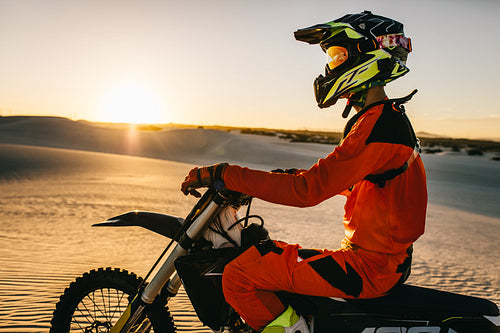 Motocross biker on his racing bike in a desert