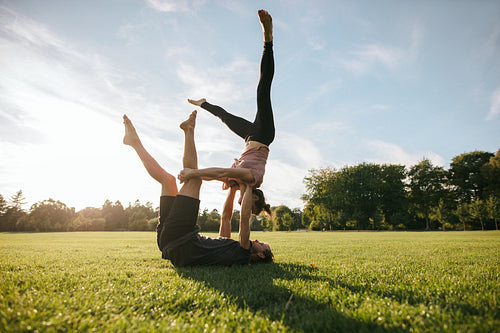 Flexible couple doing acrobatic workout