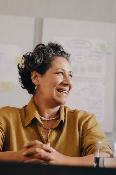 Confident and inspiring mature businesswoman smiling during a professional meeting