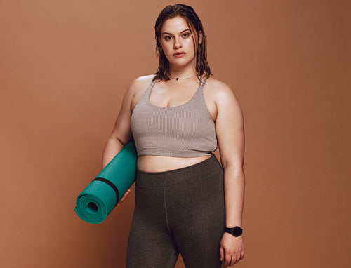 Oversized female with yoga mat