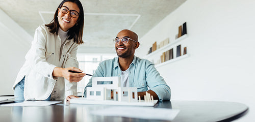 Creative designers working on a 3D model in an office