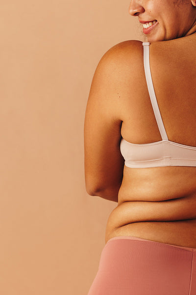 Curvy woman wearing underwear in a studio