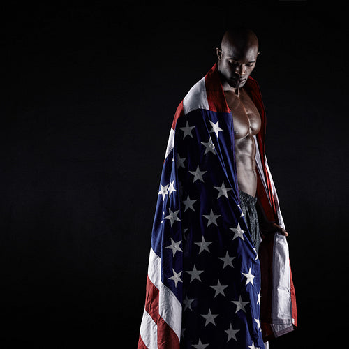 Male athlete carrying an American flag
