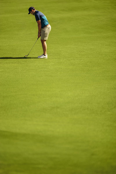 Focused professional golfer at golf resort preparing for a challenging game