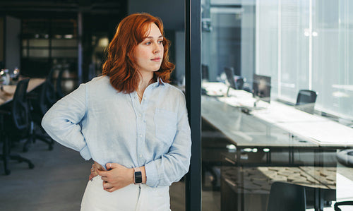 Confident female entrepreneur contemplating business strategies in office