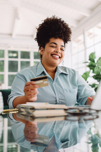 Woman enjoying doing online shopping at home