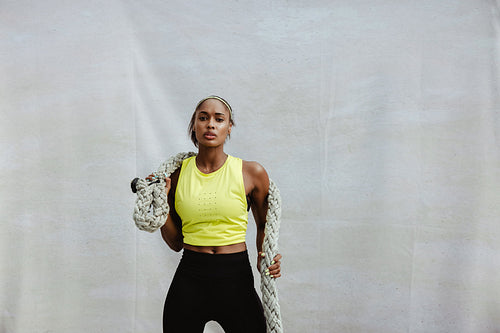 Sportswoman doing battle rope workout