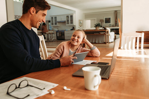 Smiling girl with her father at home