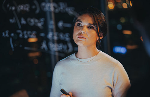 Female data analyst working late in her office
