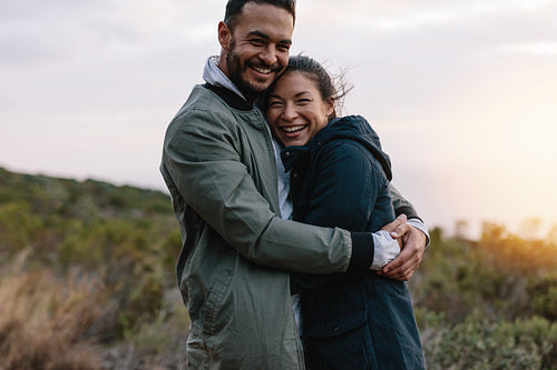 Romantic couple hugging in the countryside