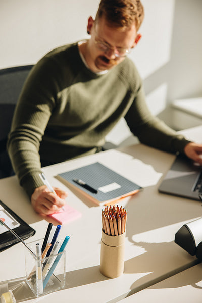 Businessman making notes working at desk