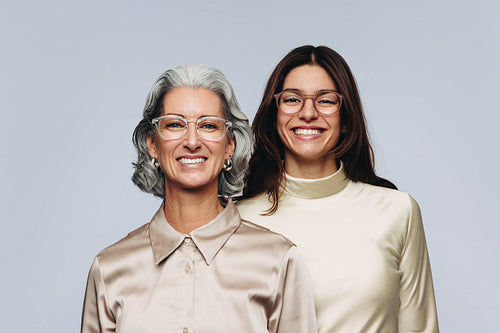 Two women model eyewear for optometry and fashion
