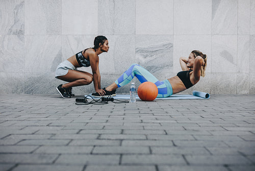 Women doing workout outdoors on a street