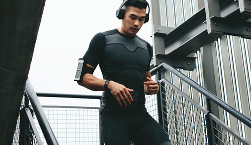 Fitness man moving down the steps