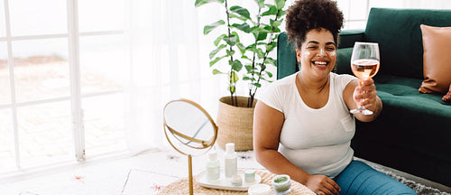 Woman having wine during beauty care routine