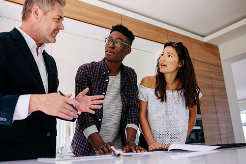 Interracial couple having consultation with a realtor