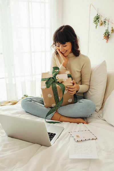 Woman on video call looking at her christmas present