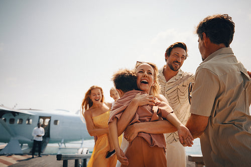 Family reunion at tropical resort as relatives arrive by seaplane