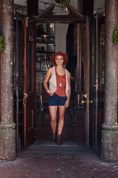 Trendy young woman leaving cafe