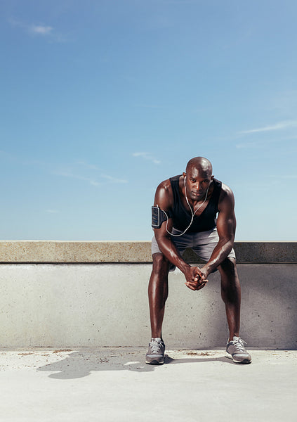 Fit young man taking rest after running workout