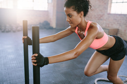 African woman doing intense workout in gym