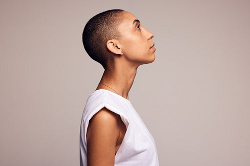 Androgynous woman with shaved head