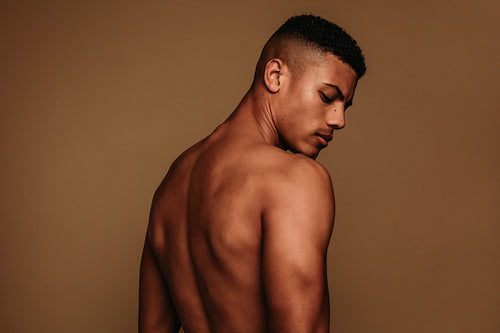 Rear view portrait of muscular african american man
