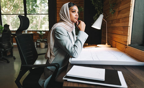 Thoughtful Muslim achitect working in a coworking space