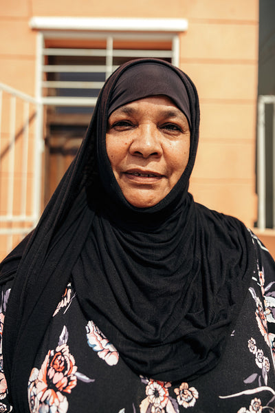 Carefree Muslim woman looking at the camera while standing outside