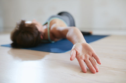 Woman stretching on an exercise mat