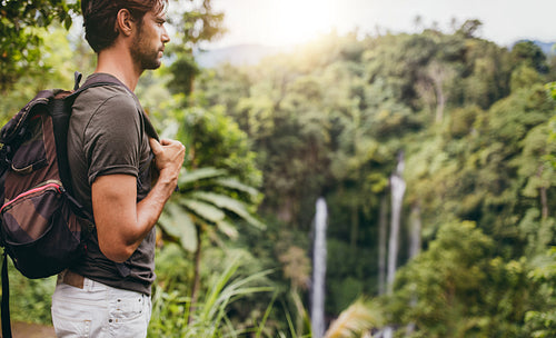 Man hiking near waterfall