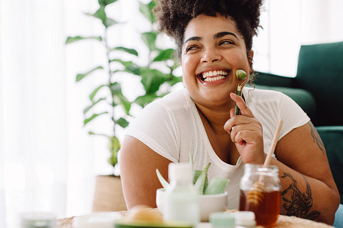 Woman taking care of her face skin with jade roller